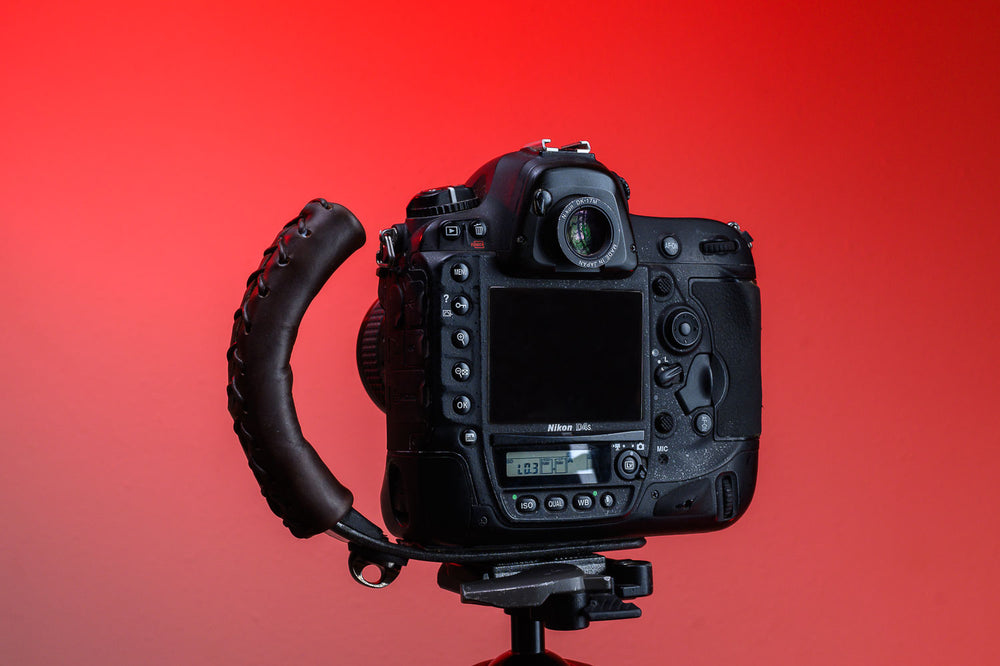 Back of Brown Leather Camera Handle on DSLR Camera with a grip attached mounted to a tripod