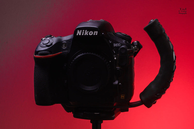 DSLR Camera attached to a Camera Handle mounted on a tripod