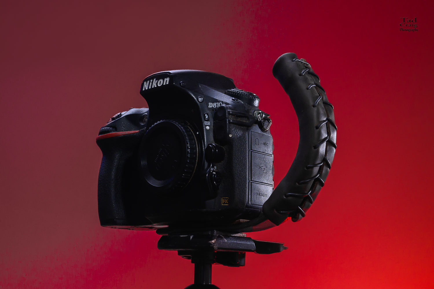 Brown Leather Camera Handle on DSLR Camera with a grip attached mounted to a tripod 