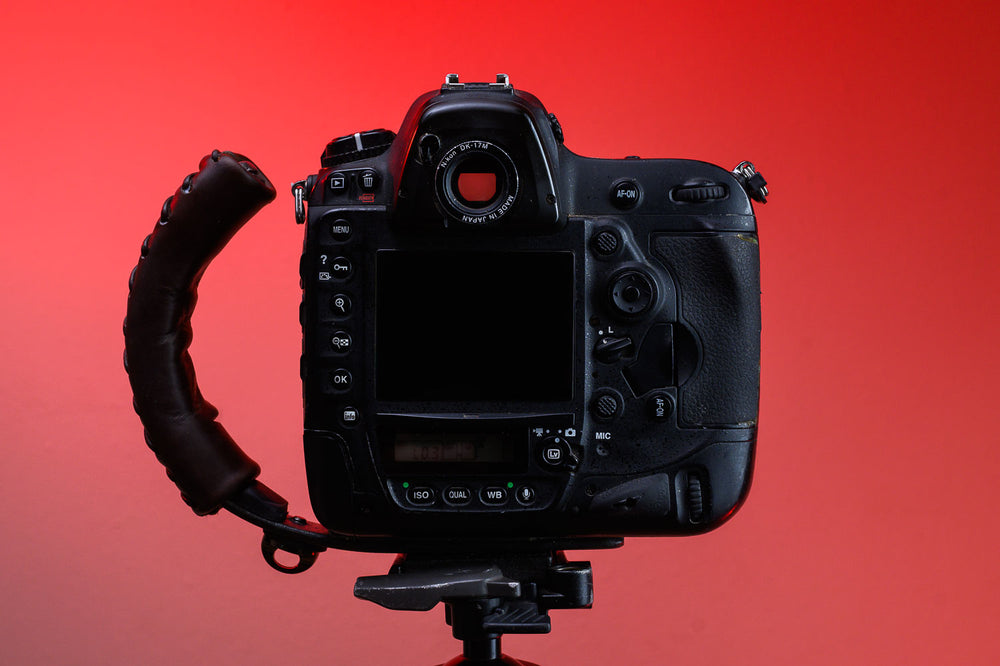 Back of Brown Leather Camera Handle on DSLR Camera with a grip attached mounted to a tripod 
