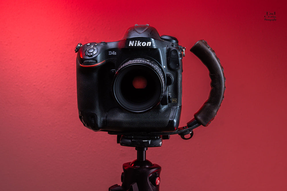 DSLR Camera attached to a Camera Handle mounted on a tripod