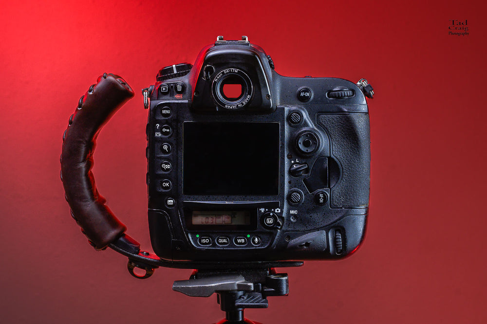 DSLR Camera attached to a Camera Handle mounted on a tripod